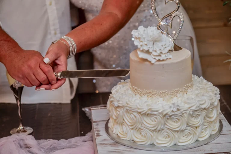 The cake cutting of the bride and groom shot by a professional gulf shores wedding photographer.