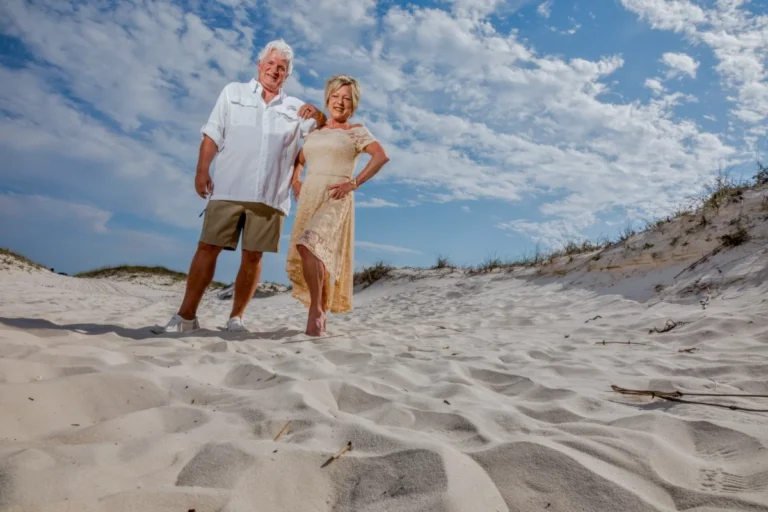 Bride and groom standing on the beach on a beautiful day from Gulf Shores wedding photographer.