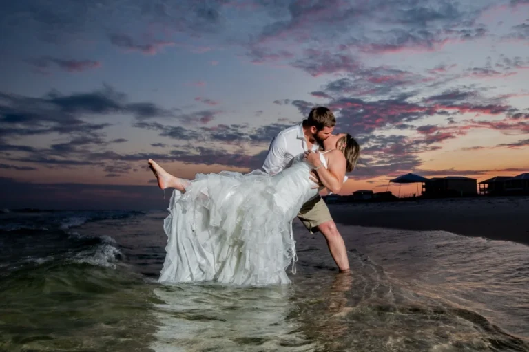 Photo of the bride and groom at sunset kissing each other shot by Gulf Shores photographer