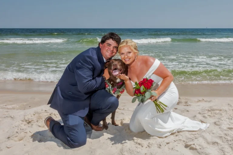 Bride and groom with their pet dog on the beach Shot by Gulf Shores photographer
