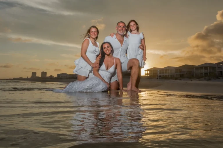 Part of the wedding bridal party on the beach with a nice reflection with the sunset beside them. Gulf Shores Photographer
