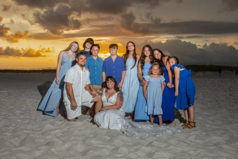 Gulf Shores Wedding Photographer Wedding Group Shot into the sunset on the beach.
