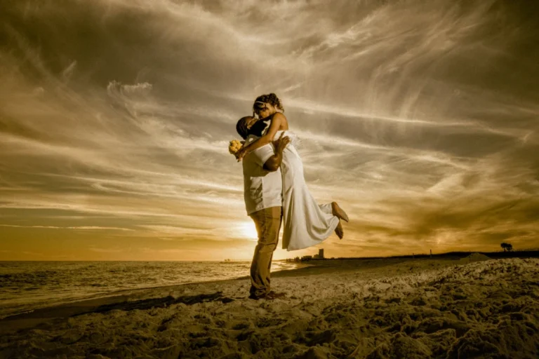 Bride and groom on the beach into the sunset shot by a gulf course photographer.