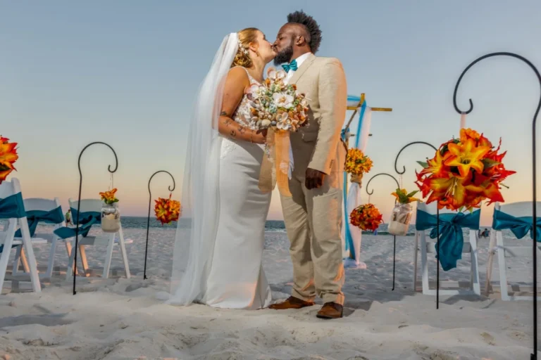 Riding groom on the beach right after their wedding shot by a Gulf Shores photography