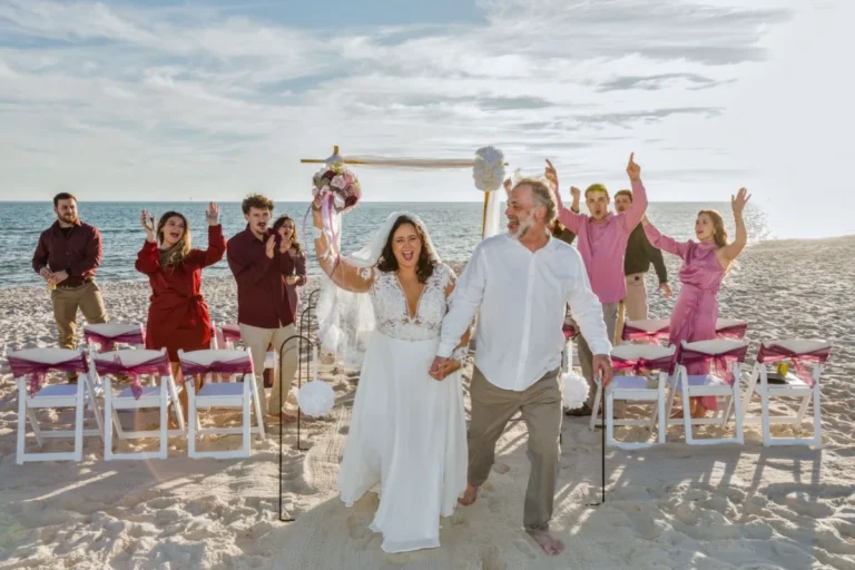 Bride and groom walking down the aisle at the end of the wedding by Gulf Shores photographers.